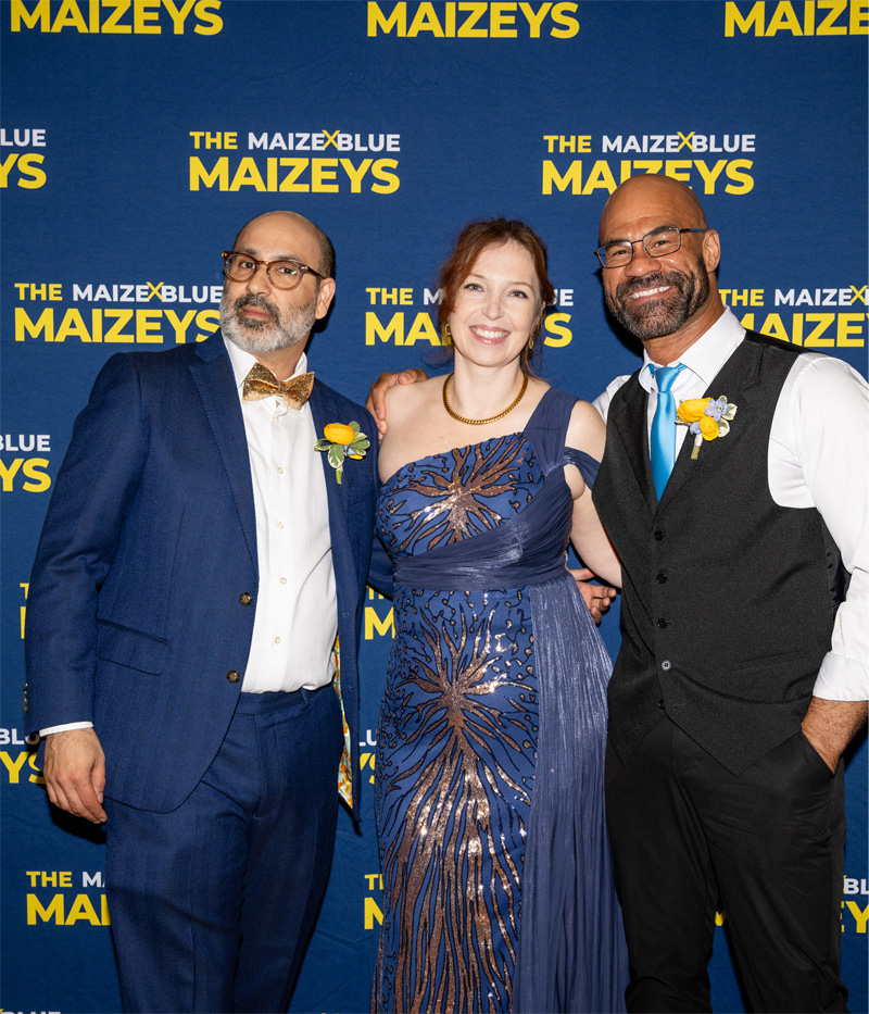 Presenters of the Maizey awards stand in front of a Maizey branded backdrop.