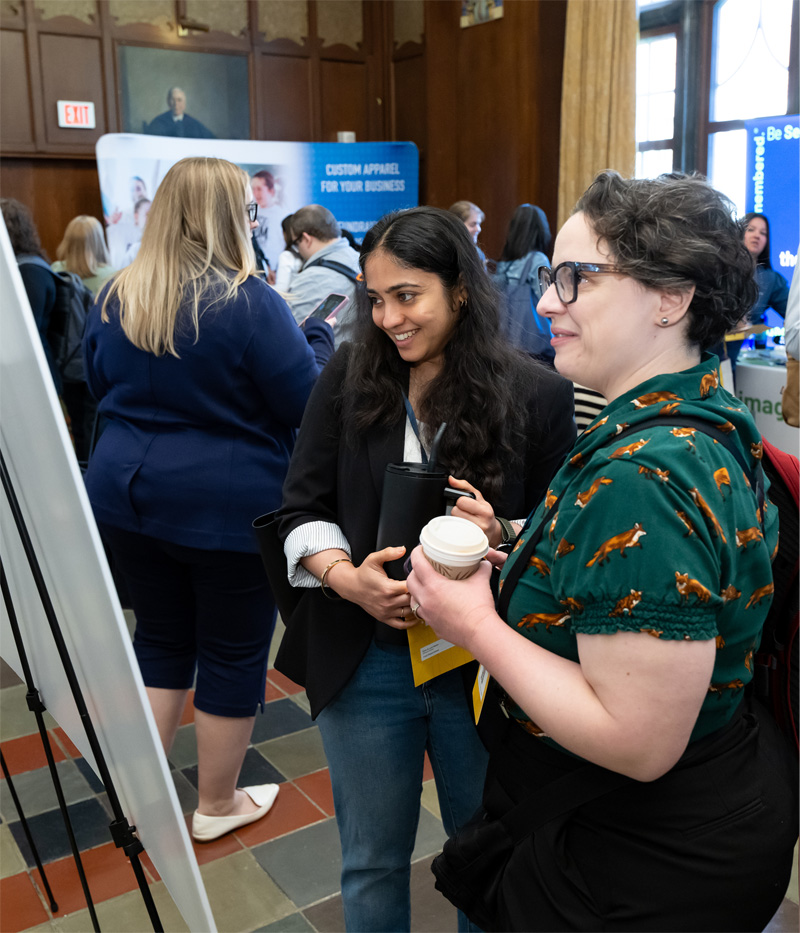 MXB attendees admire a poster at the poster session.