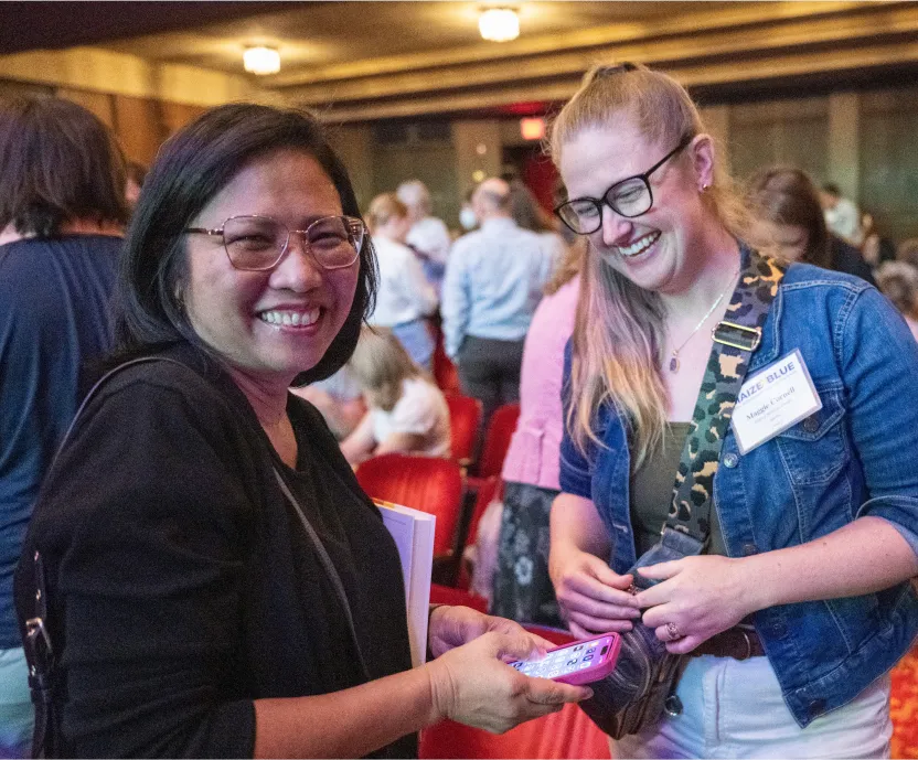 Two conference attendees talking and laughing