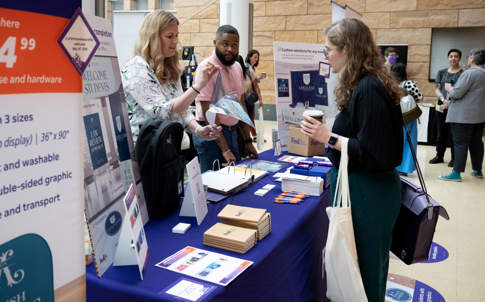 Conference attendees stop by the Fedex table