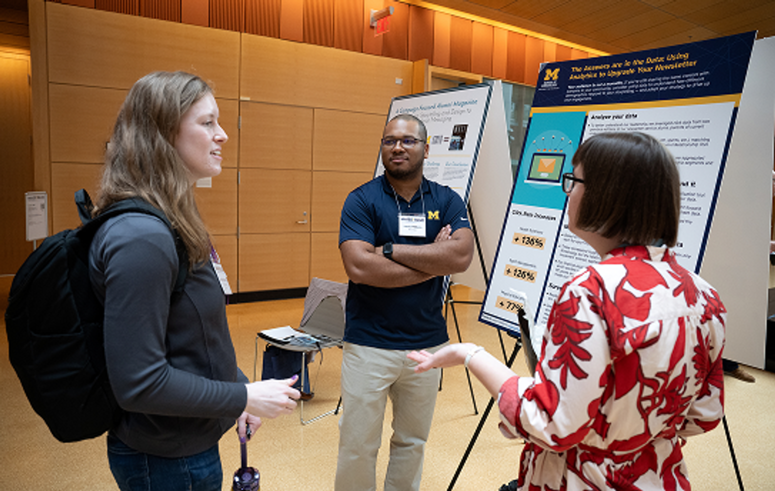 People chat in front of the posters