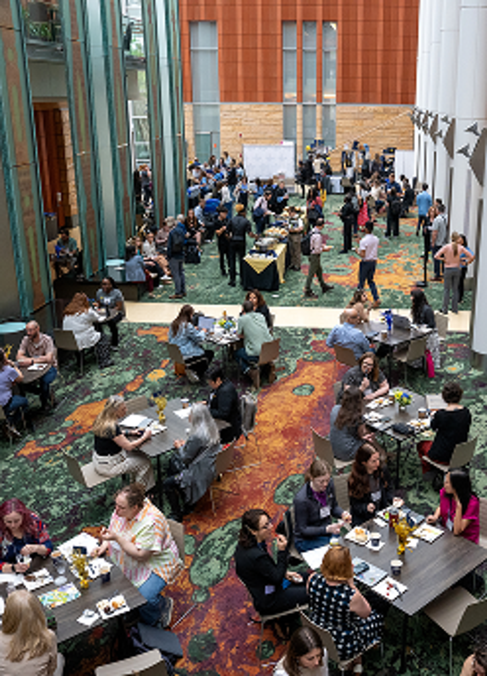 Conference goers sit at the Ross winter garden