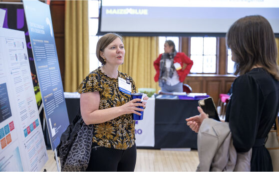 Two people speaking about the conference posters